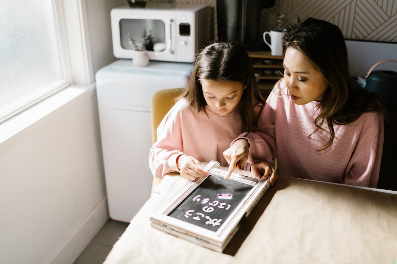 A mother and daughter engage in educational activities together at home, emphasizing bonding and learning.